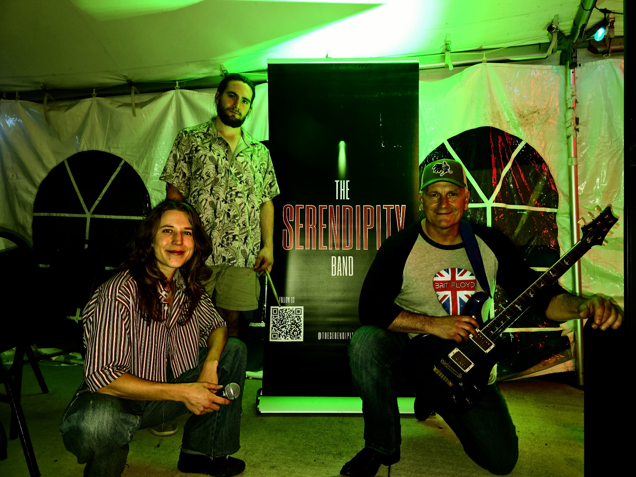 The band posing in front of The Serendipity Band banner